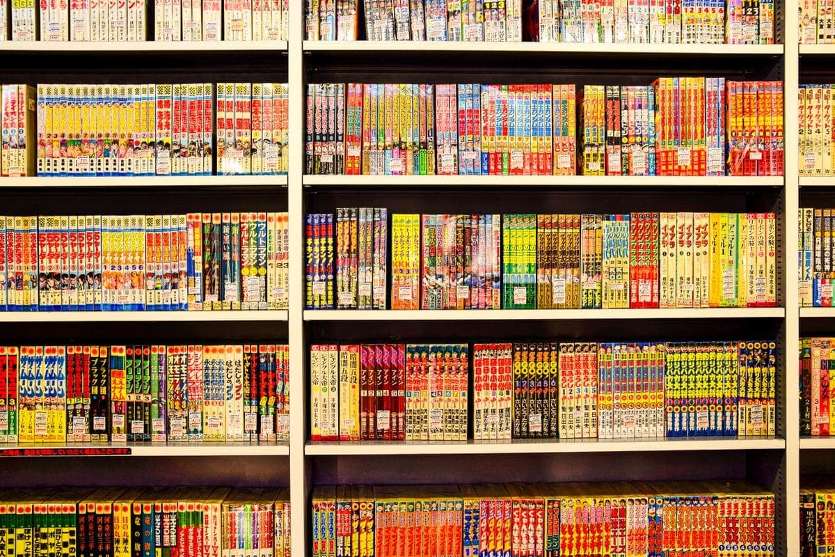 Shelves packed with colorful manga volumes in a Japanese bookstore
